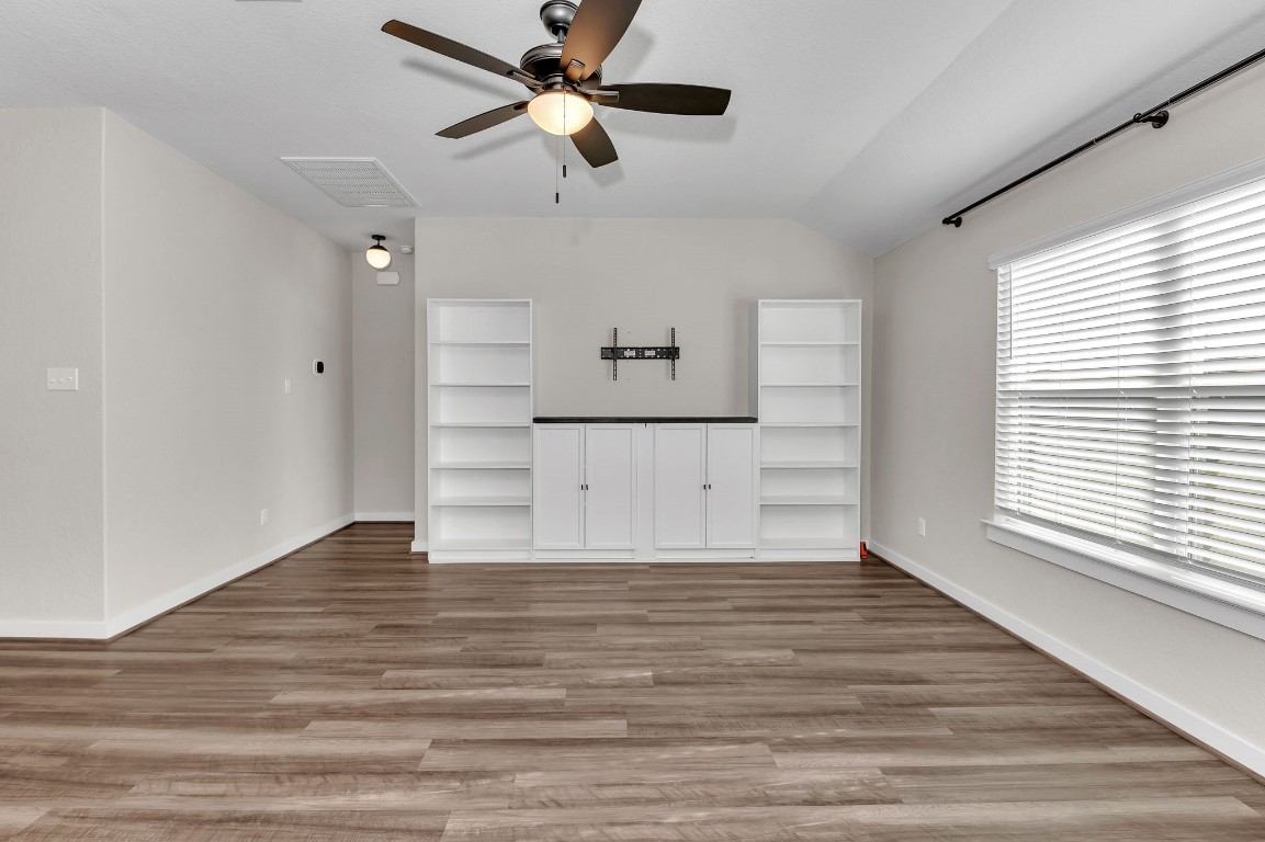 300 Colthorpe Lane Hutto, TX 78634 - Photo 21 of 36 wooden floor in an empty room with a window