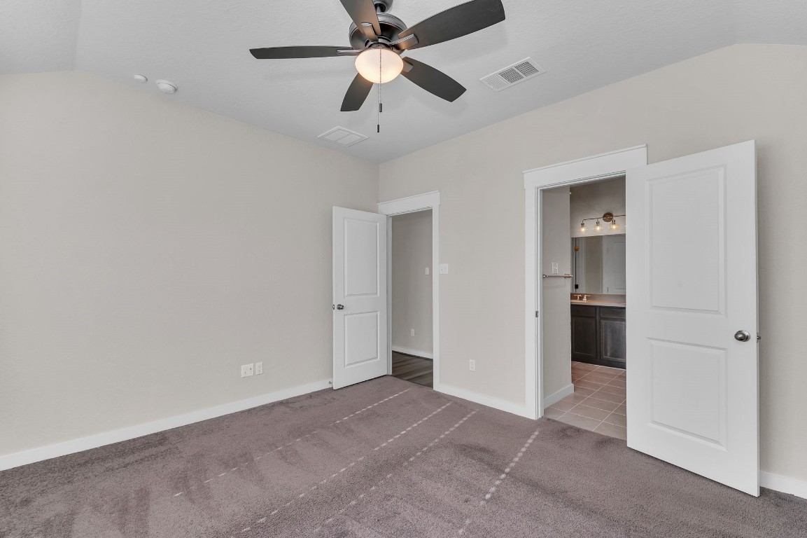 300 Colthorpe Lane Hutto, TX 78634 - Photo 22 of 36 an empty room with closet and a ceiling fan