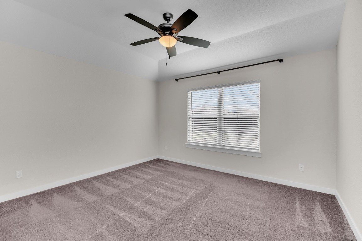 300 Colthorpe Lane Hutto, TX 78634 - Photo 23 of 36 an empty room with a window and a fan