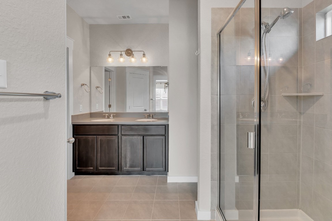 300 Colthorpe Lane Hutto, TX 78634 - Photo 24 of 36 a bathroom with a sink and a mirror