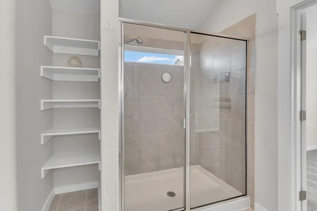 a bathroom with a sink toilet vanity and shower