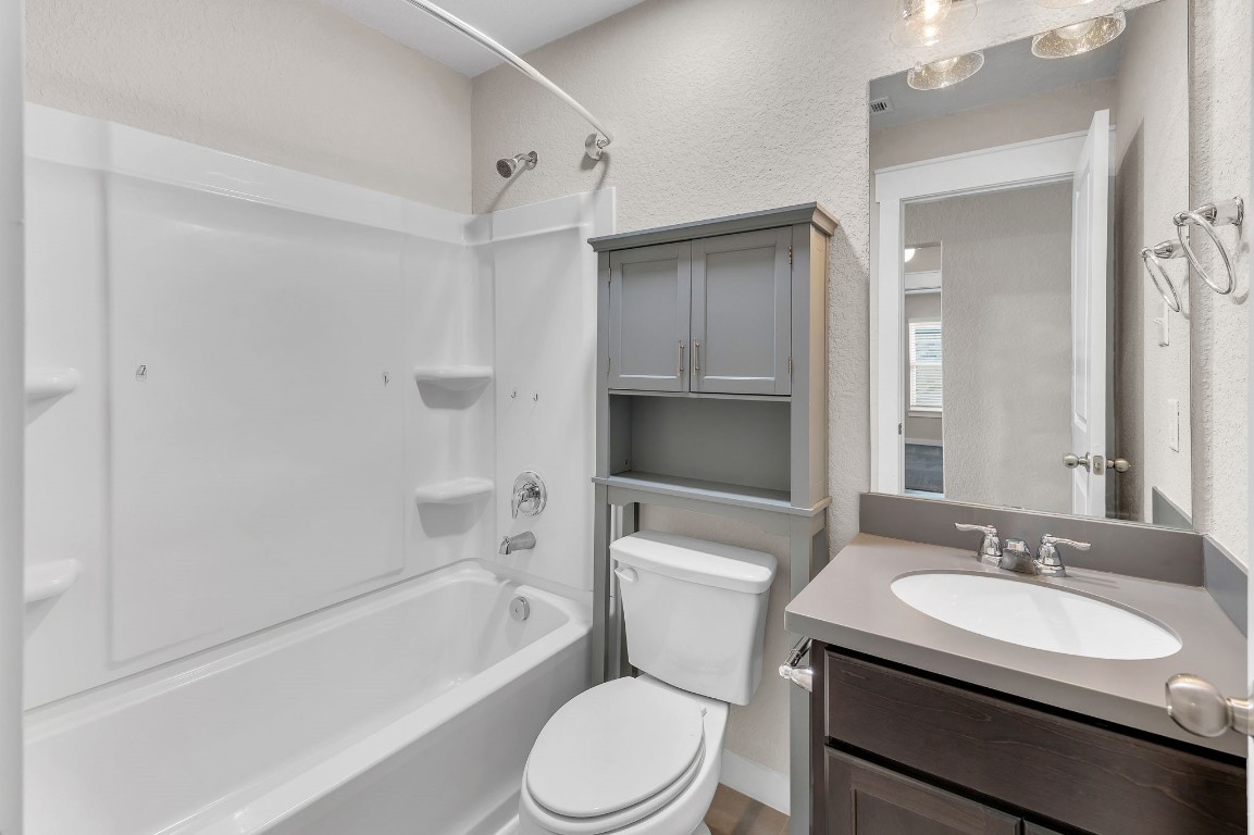 300 Colthorpe Lane Hutto, TX 78634 - Photo 32 of 36 a bathroom with a sink toilet vanity and shower