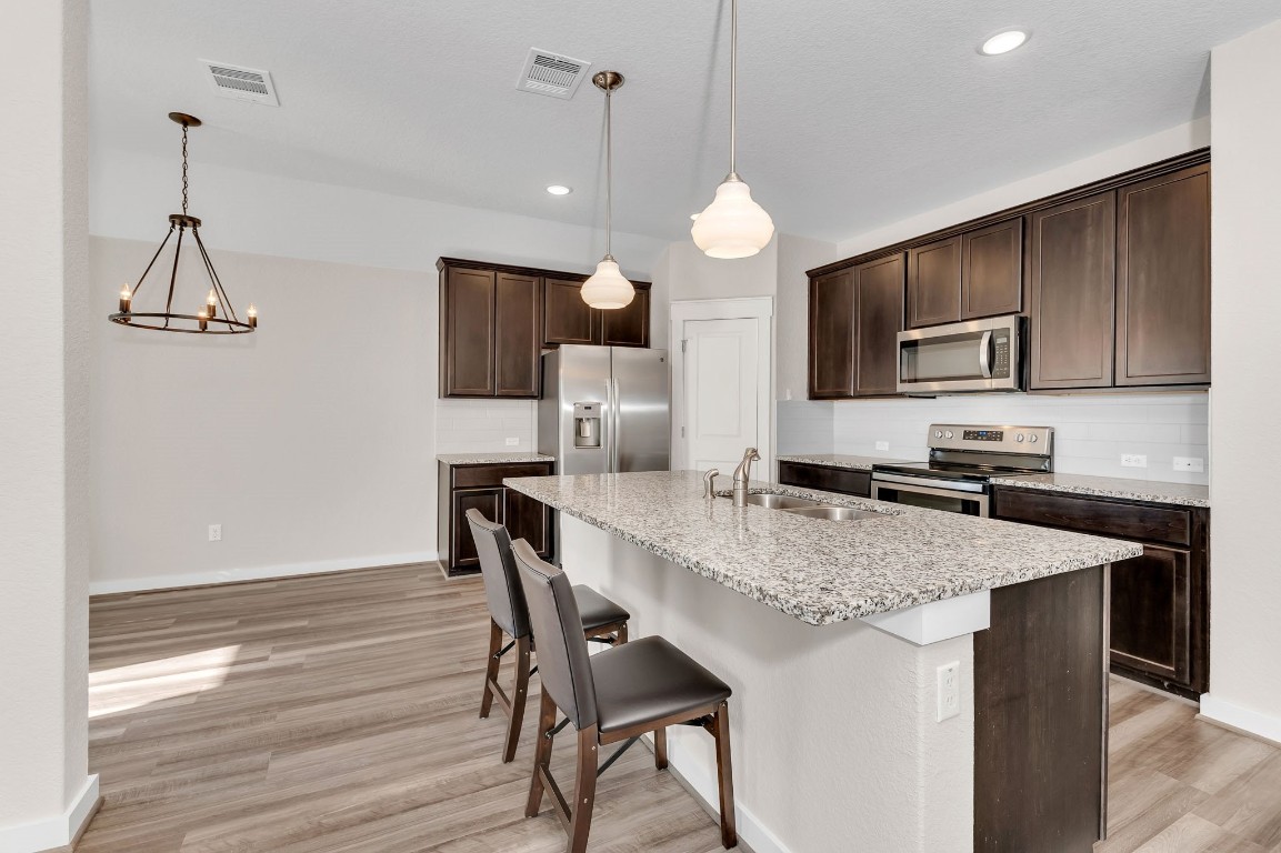 300 Colthorpe Lane Hutto, TX 78634 - Photo 7 of 36 a kitchen with a table and chairs in it
