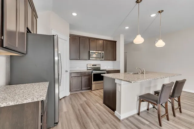 a kitchen with a sink stainless steel appliances and cabinets