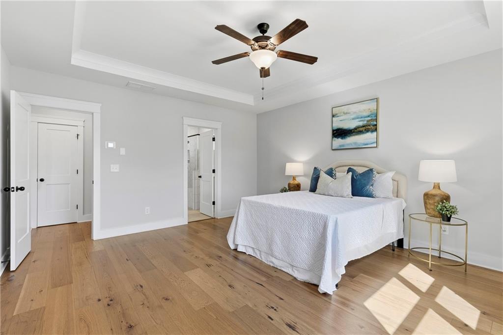 203 Sunshower Ridge Canton, GA 30114 - Photo 20 of 58 a bedroom with a bed and a chandelier