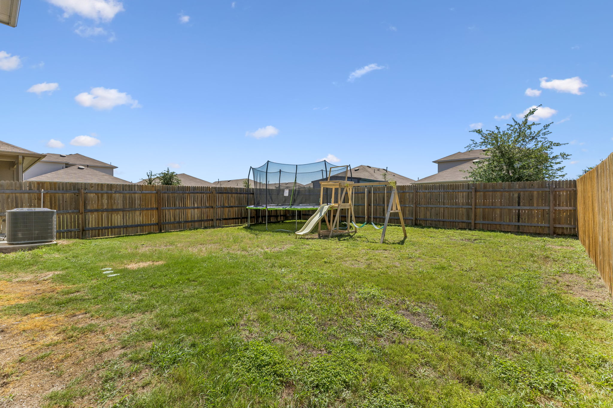 343 Sickle Loop Kyle, TX 78640 - Photo 36 of 40 Expansive backyard featuring a full wood fence perimeter and a central grassy area