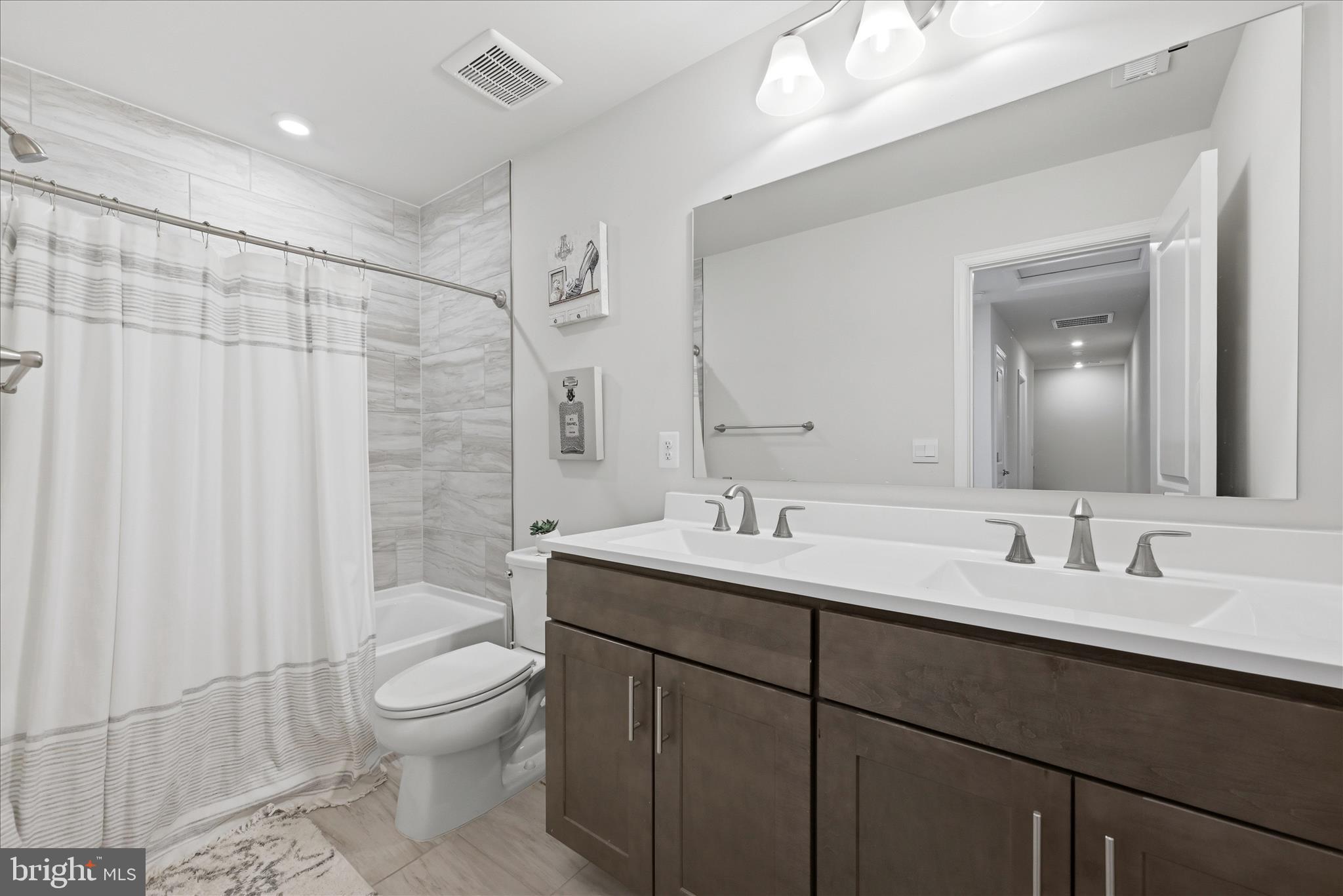 73 Hopkins Street Ranson, WV 25438 - Photo 21 of 32 a bathroom with a toilet sink double vanity and mirror