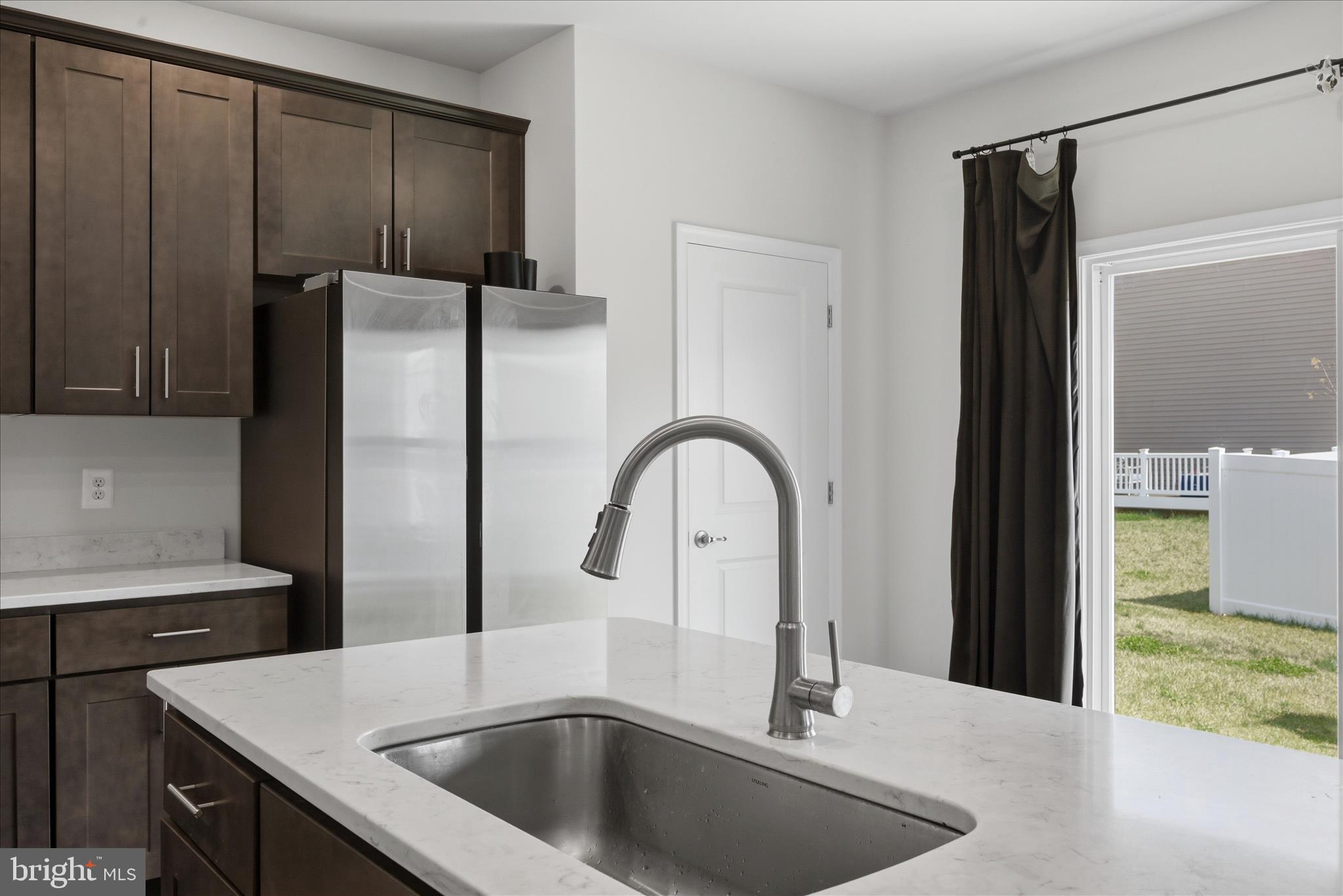 73 Hopkins Street Ranson, WV 25438 - Photo 4 of 32 a kitchen with a sink a refrigerator and cabinets