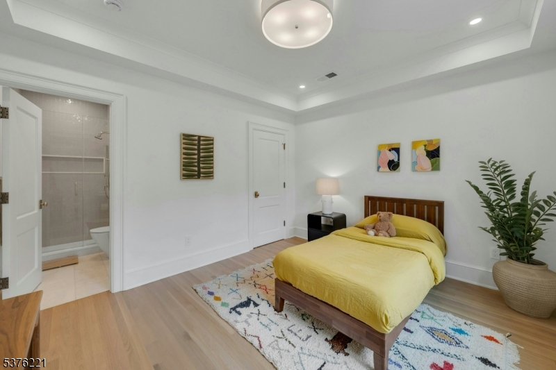 82 Watchung Avenue Montclair, NJ 07043 - Photo 22 of 48 a bedroom with a bed and a potted plant