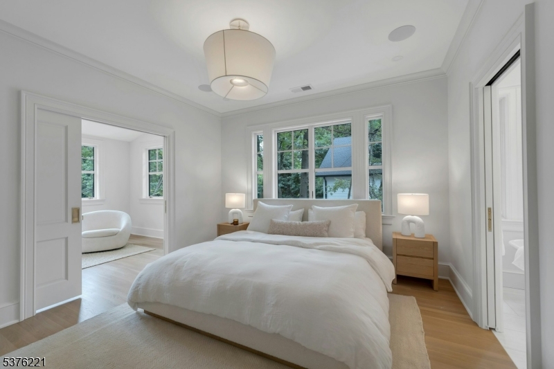 82 Watchung Avenue Montclair, NJ 07043 - Photo 25 of 48 a bedroom with a large bed and a chandelier