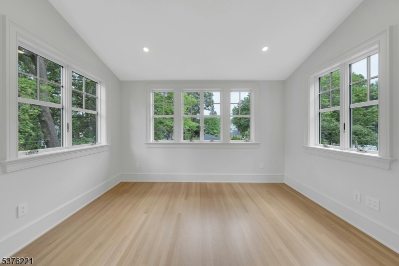 82 Watchung Avenue Montclair, NJ 07043 - Photo 26 of 48 an empty room with wooden floor and windows