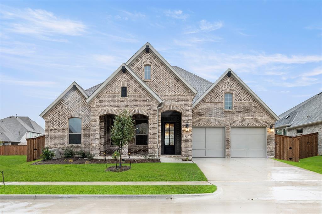a front view of a house with a garden and yard