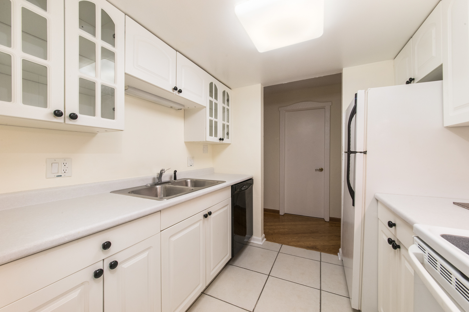 1 Renaissance Place, Unit 309 Palatine, IL 60067 - Photo 10 of 28 a kitchen with a sink and a refrigerator