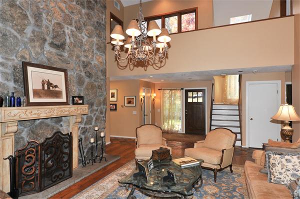 75 Lincoln Road Wayland, MA 01778 - Photo 13 of 27 a living room with furniture a chandelier and a fireplace