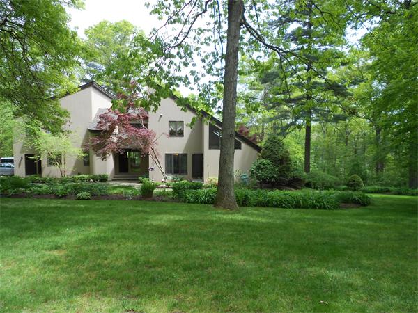 75 Lincoln Road Wayland, MA 01778 - Photo 2 of 27 a view of a white house next to a yard with big trees