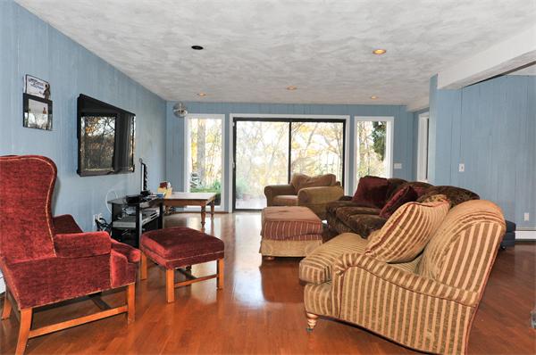 75 Lincoln Road Wayland, MA 01778 - Photo 24 of 27 a living room with furniture a large window and wooden floor
