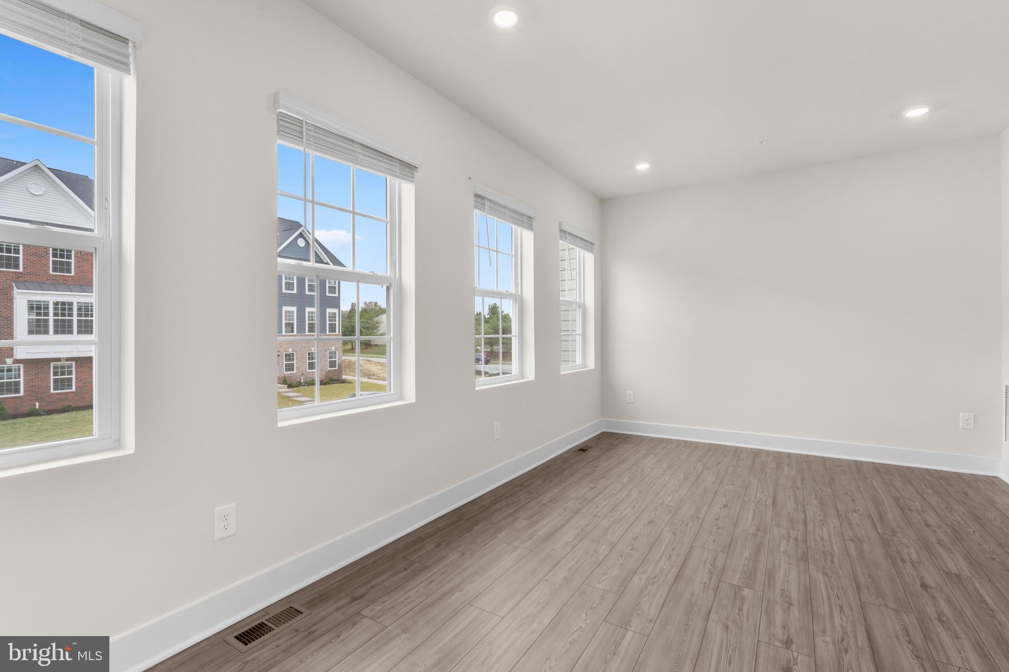 1826 Parham Way Windsor Mill, MD 21244 - Photo 17 of 37 a view of an empty room with wooden floor and a window