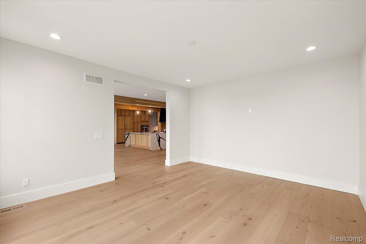 13459 Haddon Street Fenton, MI 48430 - Photo 18 of 84 Empty room with light wood-style flooring and recessed lighting