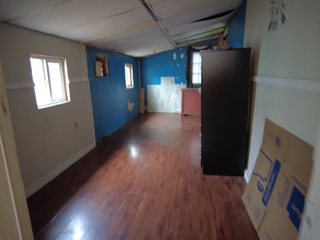 26 Easy Way Springfield, MA 01119 - Photo 9 of 13 a view of an empty room with wooden floor and a window
