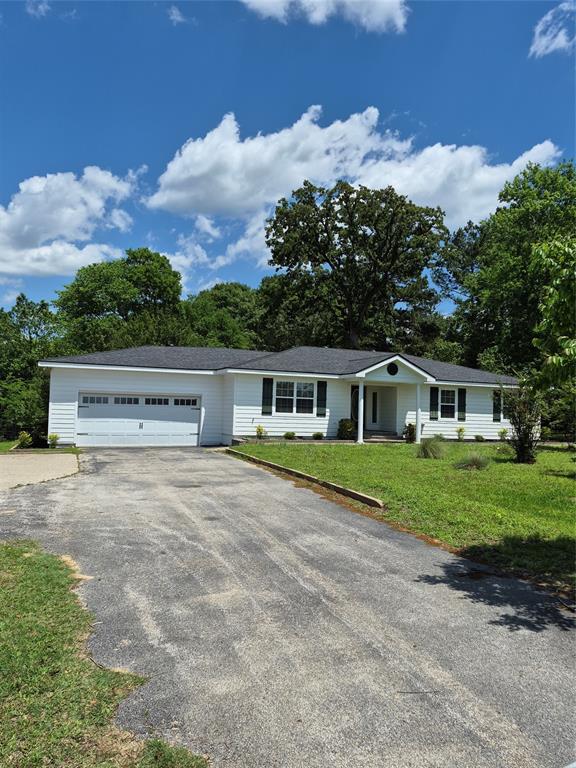 1497 West Loop 571 South Henderson, TX 75654 - Photo 1 of 25 a front view of a house with a yard