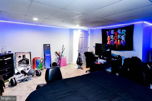 a room with gym equipment and a flat screen tv