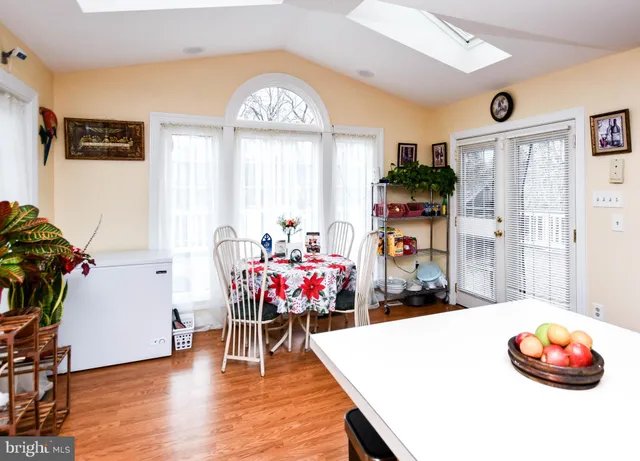 a dining room with furniture and wooden floor