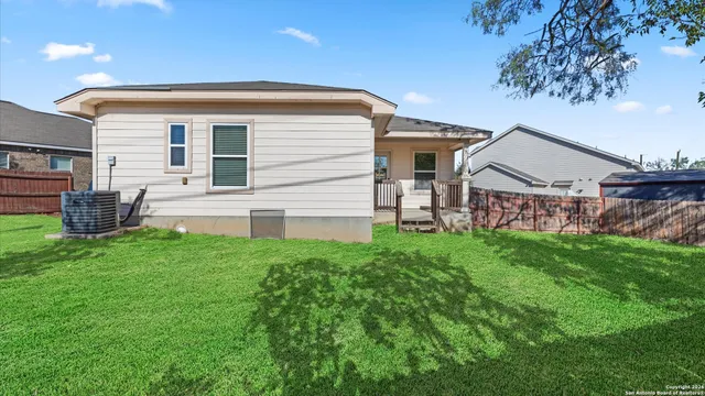 a view of a house with backyard and a garden