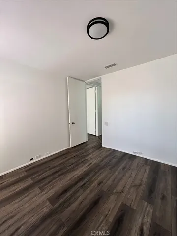 a view of room with wooden floor