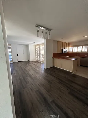 a view of a living room hardwood and kitchen