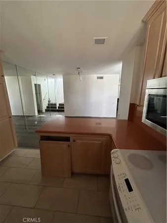 a kitchen with sink cabinets and microwave