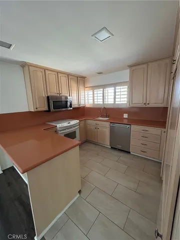 a kitchen with cabinets and white appliances