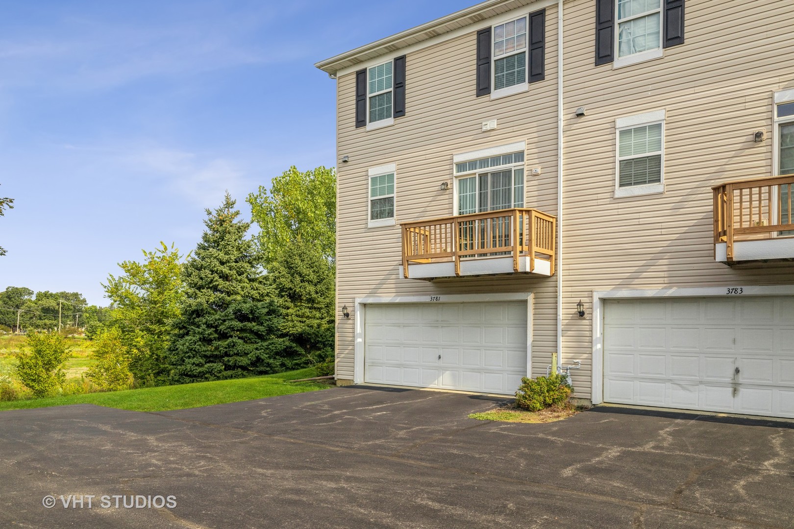 3781 Bailey Road, Unit 404 Yorkville, IL 60560 - Photo 20 of 21 a front view of a house with a yard and garage