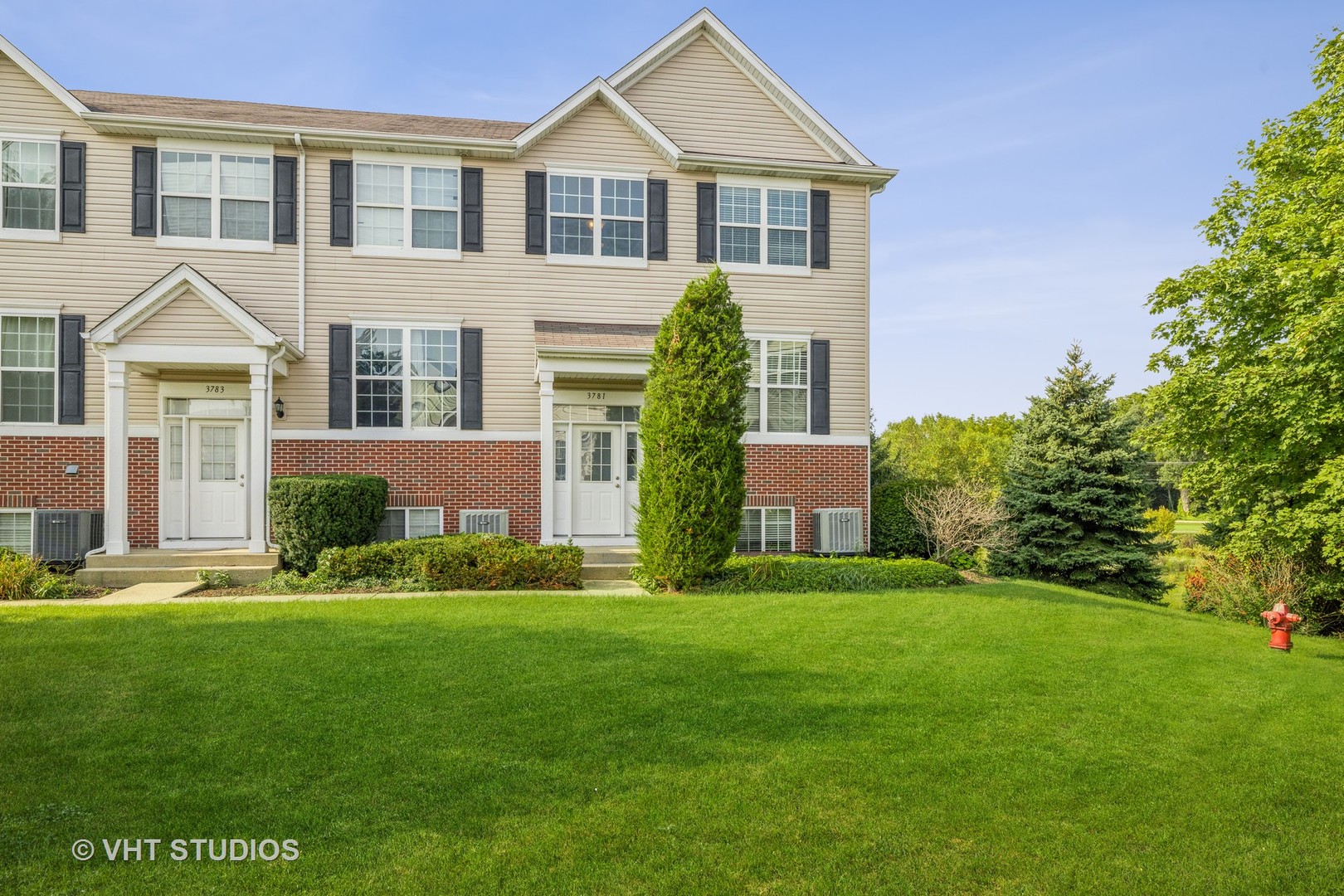 3781 Bailey Road, Unit 404 Yorkville, IL 60560 - Photo 2 of 21 a front view of a house with a yard