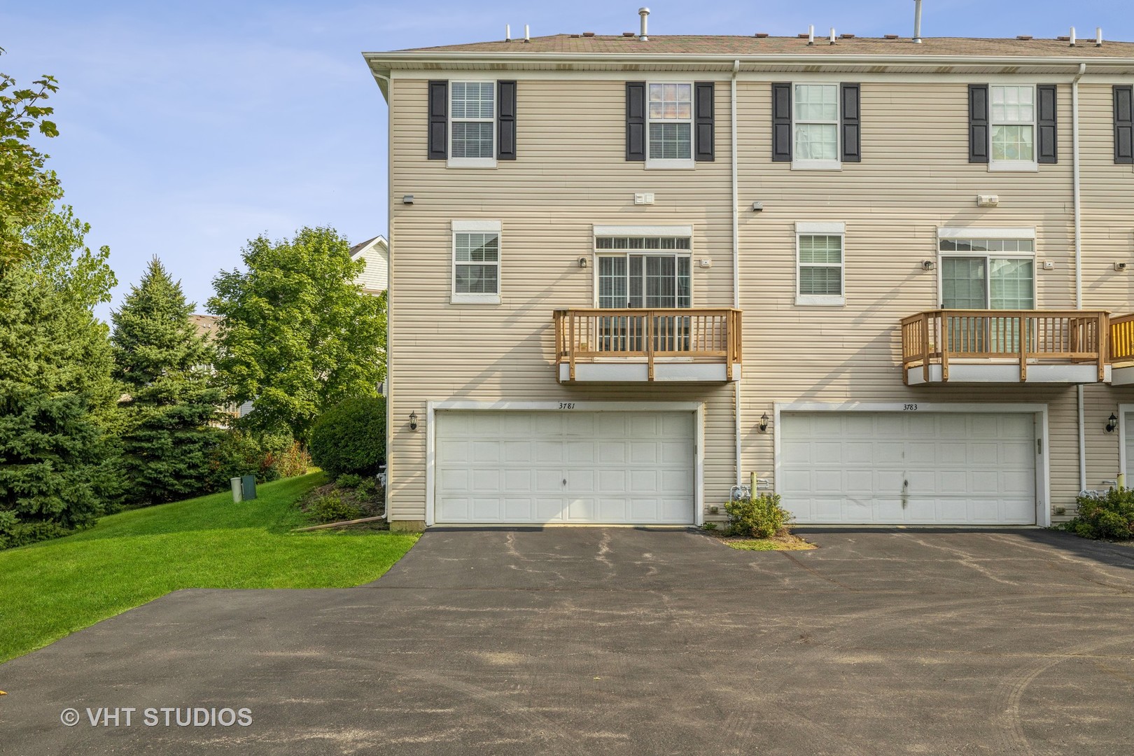 3781 Bailey Road, Unit 404 Yorkville, IL 60560 - Photo 21 of 21 a front view of a house with a yard and garage