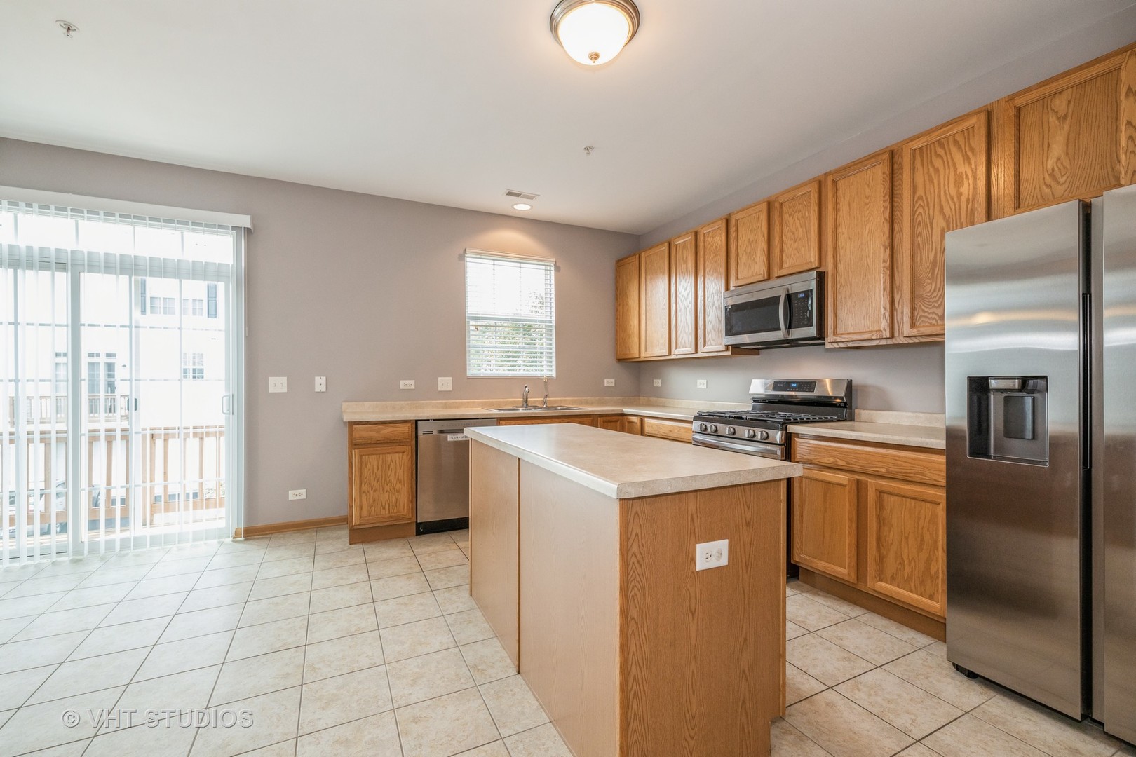 3781 Bailey Road, Unit 404 Yorkville, IL 60560 - Photo 6 of 21 a kitchen with stainless steel appliances granite countertop a refrigerator sink and stove