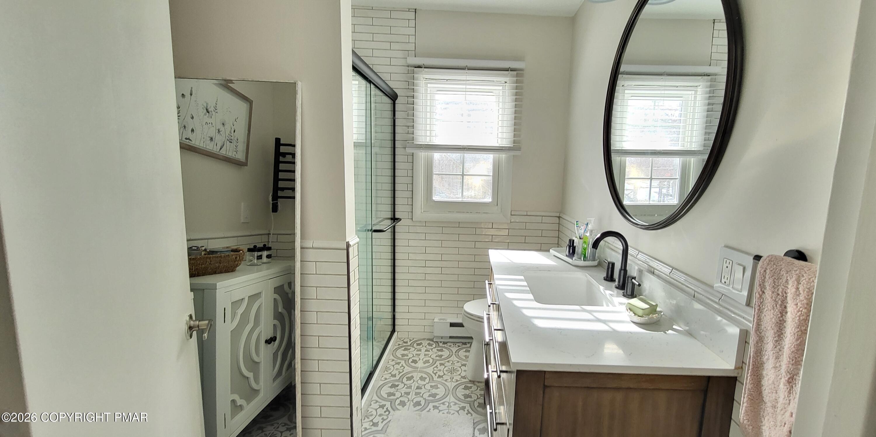 1093 Porter Drive Bushkill, PA 18324 - Photo 16 of 66 a bathroom with a sink a mirror and a window