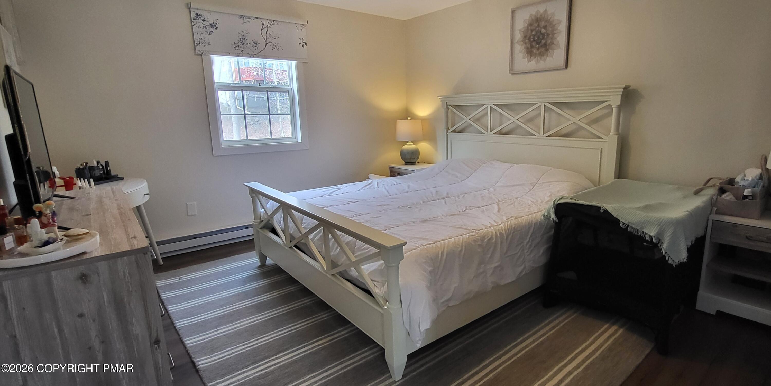 1093 Porter Drive Bushkill, PA 18324 - Photo 17 of 66 a bedroom with a bed and wooden floor