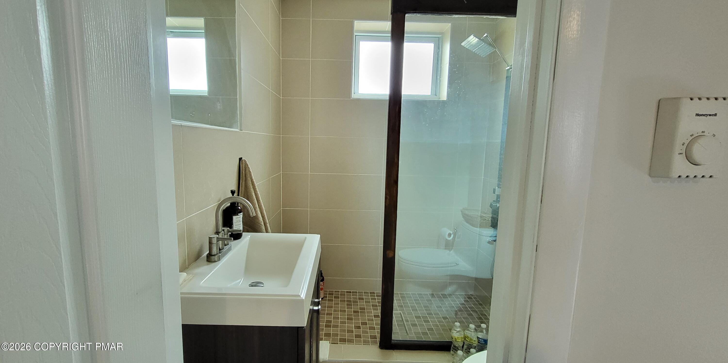 1093 Porter Drive Bushkill, PA 18324 - Photo 36 of 66 a bathroom with a sink and mirror