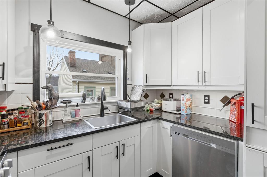 5133 Holmes Street Pittsburgh, PA 15201 - Photo 17 of 45 The kitchen features a window to the backyard and crisp white cabintes