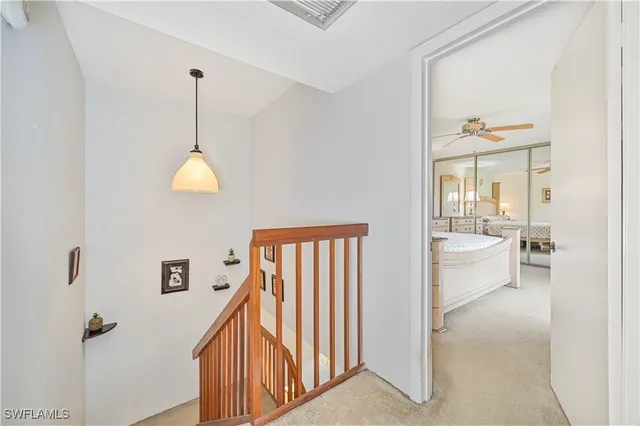 a view of a hallway with bathroom and front door