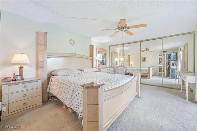 a spacious bedroom with a bed and a chandelier