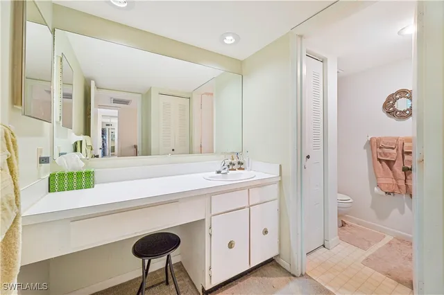 a bathroom with a sink a vanity and a mirror