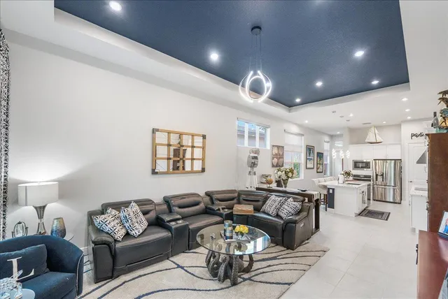 a dining room with furniture a chandelier and wooden floor