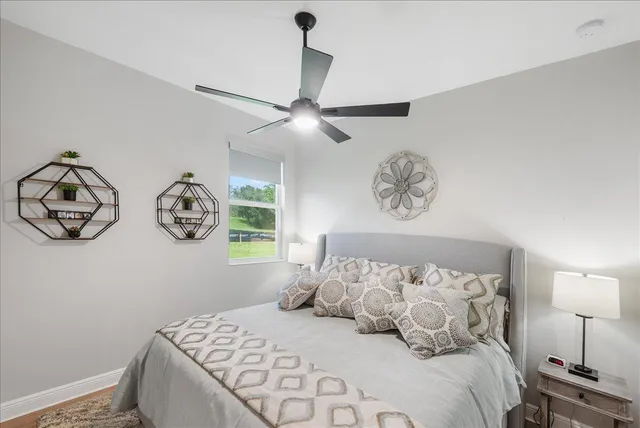 a bedroom with a bed and a lamp