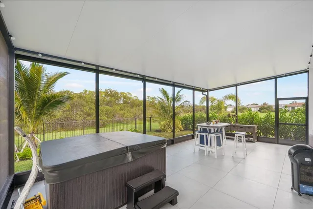 a balcony with furniture and a large window