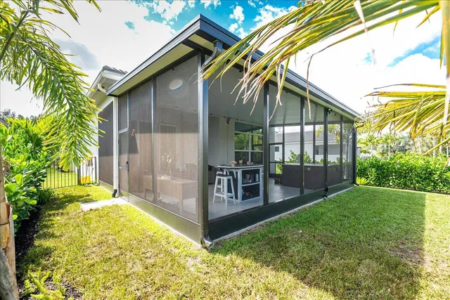 a view of an house with backyard and porch