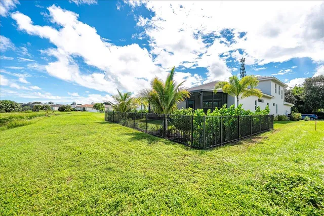 a view of a house with swimming pool and sitting area