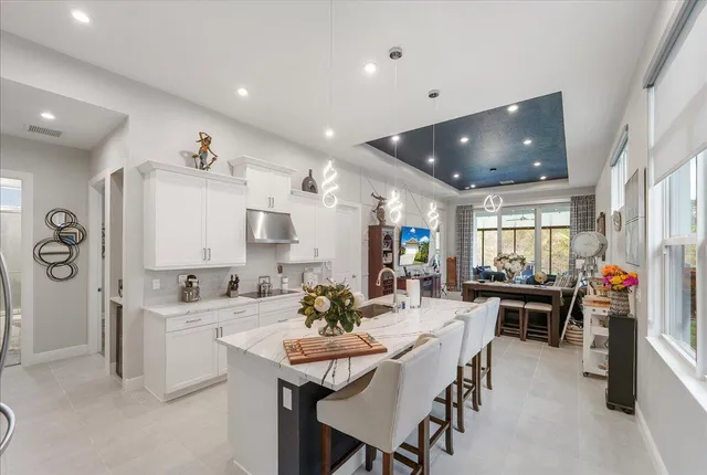 a large white kitchen with a large window