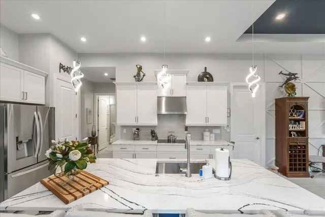 a kitchen with stainless steel appliances kitchen island granite countertop a sink and cabinets
