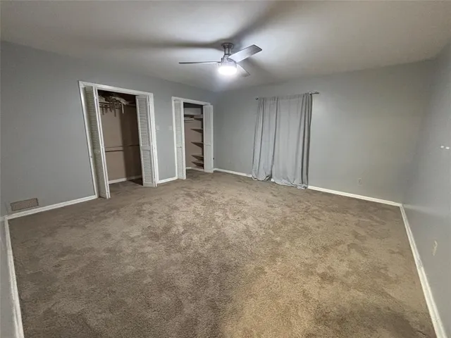 a view of an empty room and closet